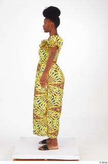 Dina Moses A poses dressed standing whole body yellow long…